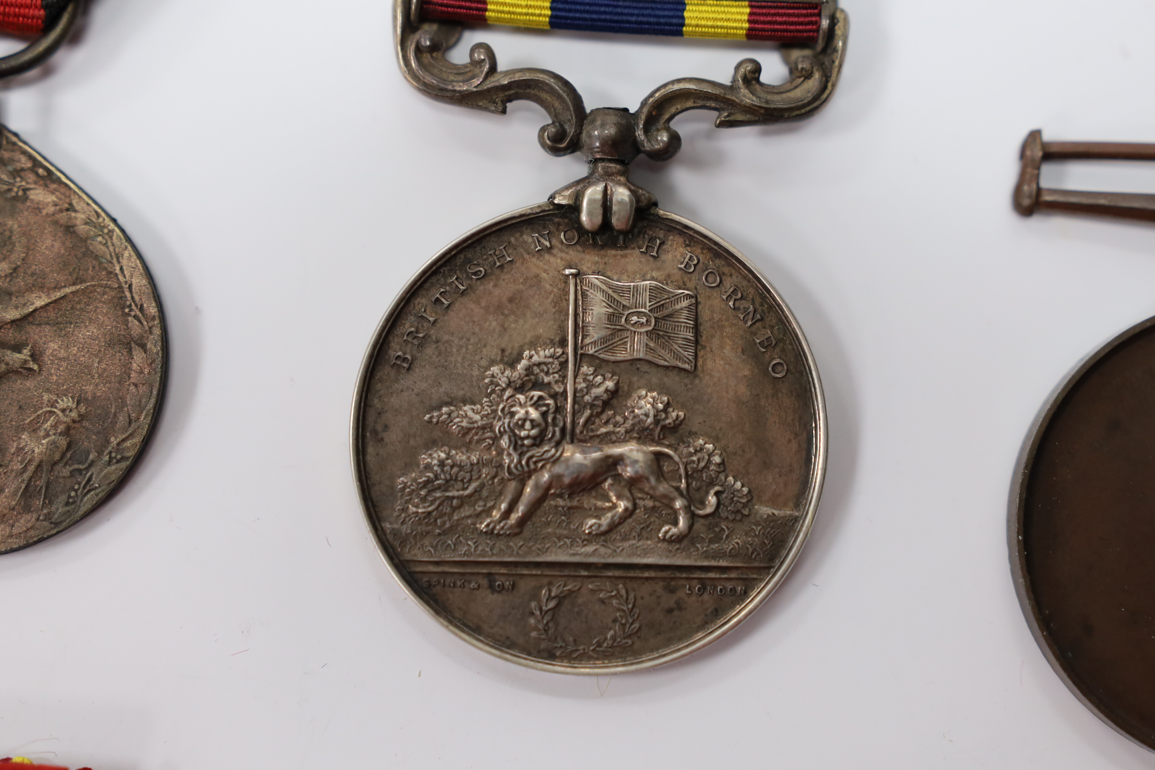 Assorted medals; two replica British North Borneo medals; Balaklava medallion; bronze GV medal; German China Campaign medal; bronze NRA medallion, unnamed